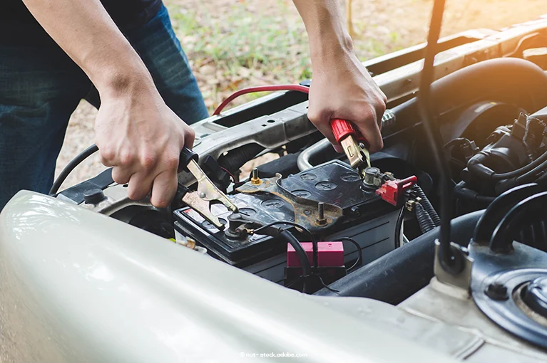 A man attempts to jump his battery in his car. The batteries in 2017–2019 Honda Accord and Honda CR-V vehicles allegedly fail to power the vehicles.