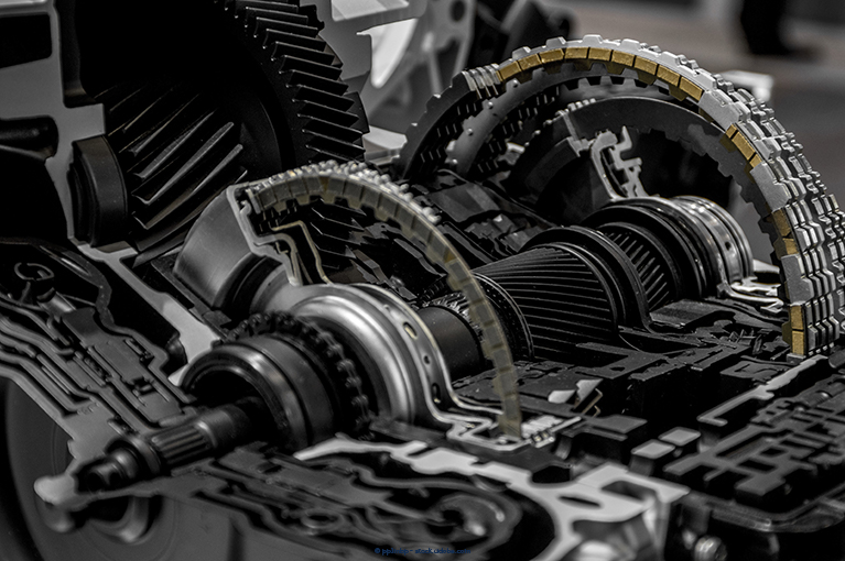 The interior of a transmission. Fiat Chrysler's 9-speed transmissions allegedly experience rough, delayed, or sudden shifting, failure to shift, grinding noises, harsh gear engagement, sudden or harsh acceleration and deceleration, sudden loss of vehicle power, and premature wear and/or failure of the transmission.