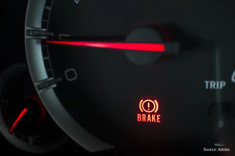 A brake light is illuminated on the speedometer, which itself indicates a speed of one mile per hour.