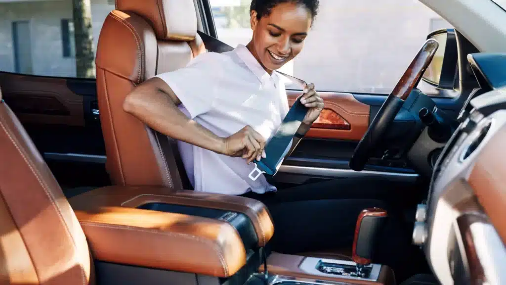 Close up of woman buckling her seatbelt