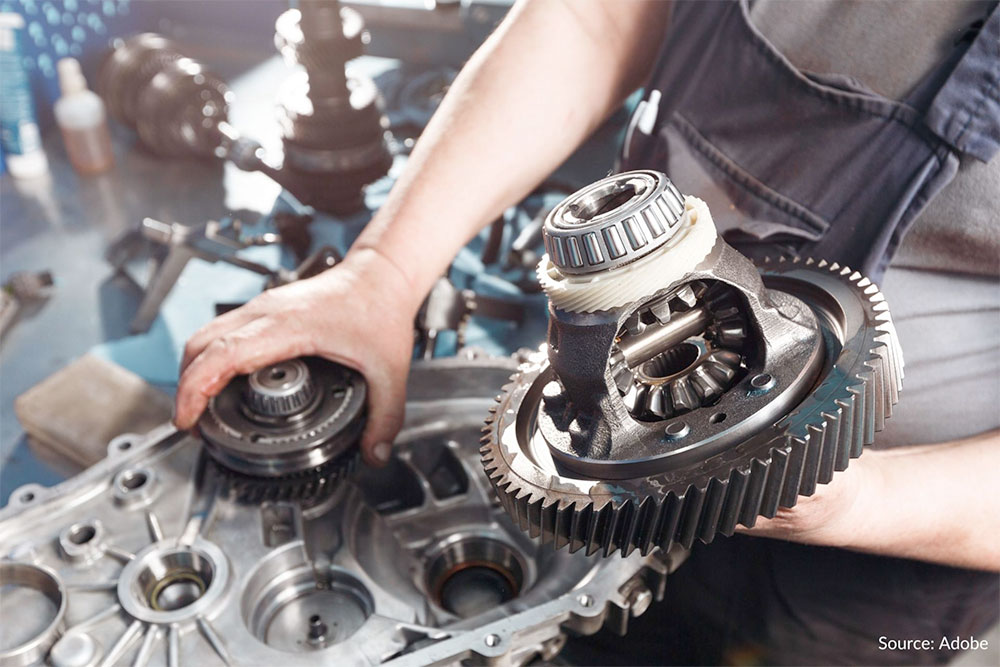 A repair technician is pulling apart components of a transmission. Model year 2011-2016 Honda Odyssey minivans allegedly experience transmission failures while accelerating from a stop, accelerating from low speeds while merging into traffic or onto highways, trying to drive uphill or shifting gears while driving at low speeds.