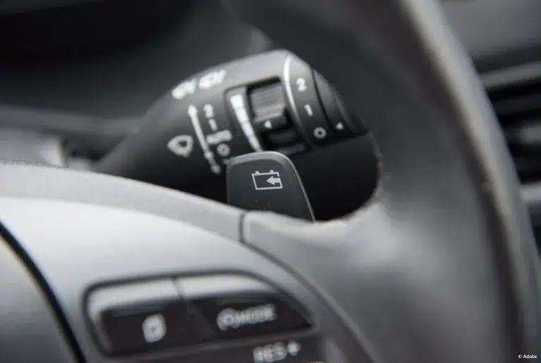 A close-up of a steering wheel and a multifunction switch (also known as a 