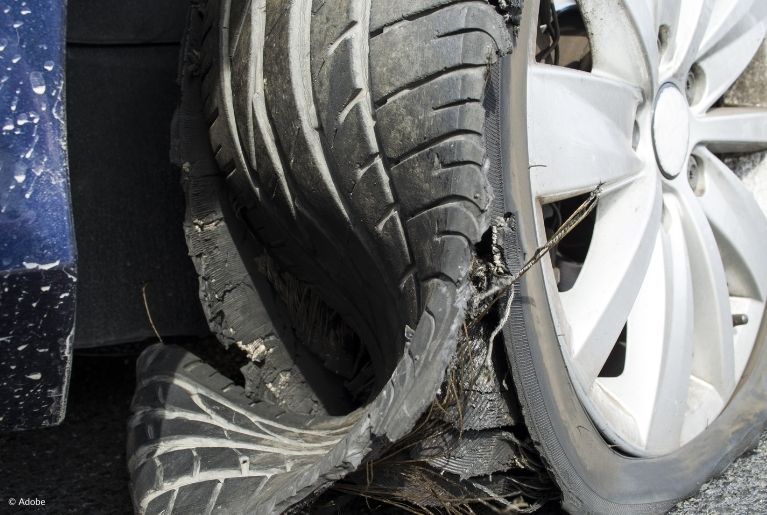 The rubber is being stripped off the tire itself, exposing the rim to the road.