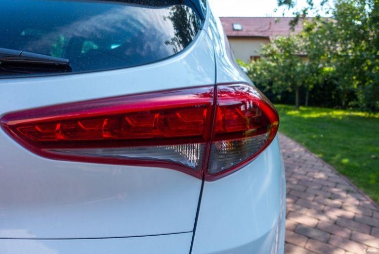 A close-up of a red taillight on a white Hyundai.