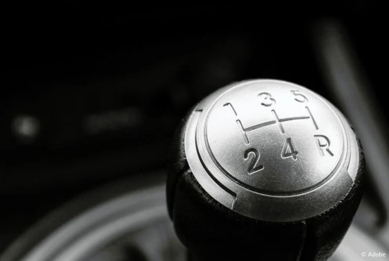 A close-up of a gearstick for a manual transmission.