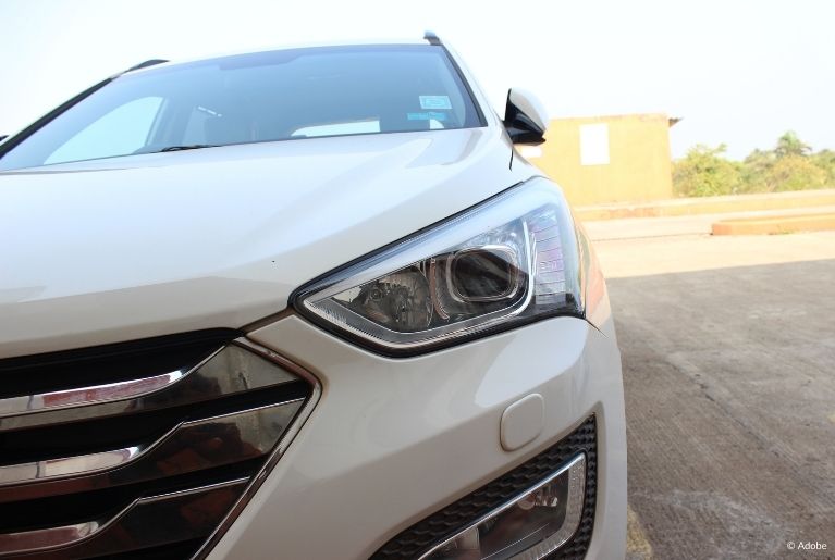 A white car is parked in an empty lot. More than 724,000 Honda Passport, Pilot and Ridgeline vehicles because damaged hood latches allow hoods to fly open while driving, obstructing the driver’s view of the road.