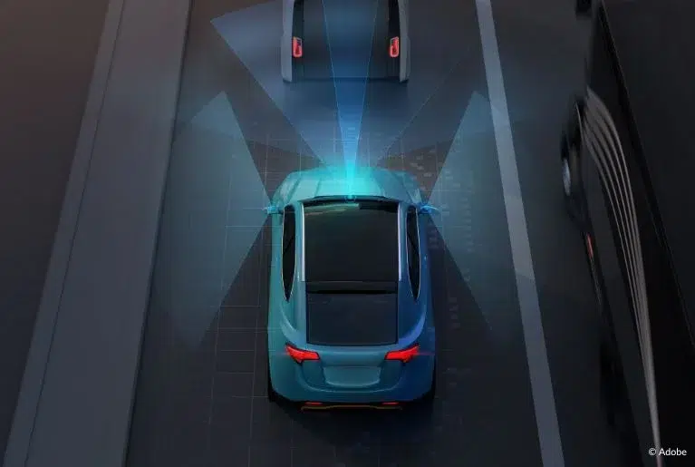 A blue car using radar sensors (represented by blue overlays) to detect a vehicle in front of it and a bus to its right.