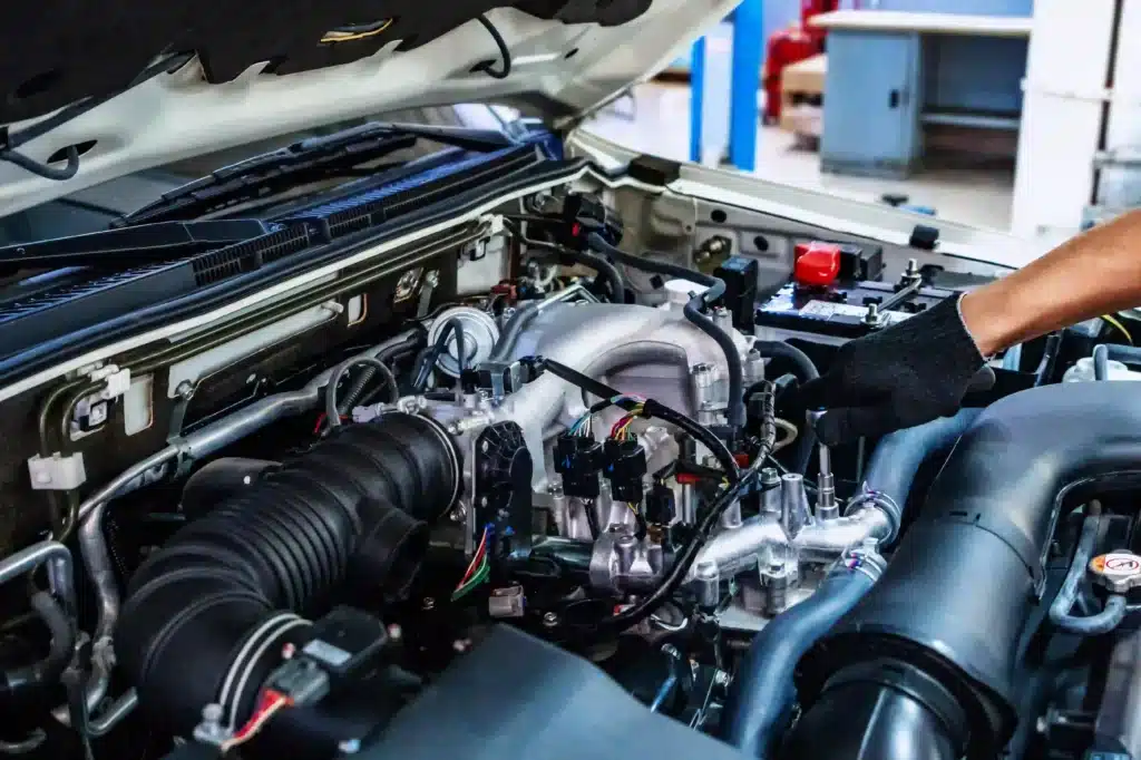 Close up of mechanic working with car hood open