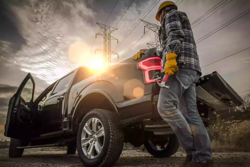 Contractor next to pickup truck in work area