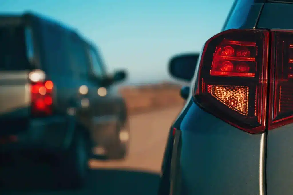Close up of rear end of two cars driving