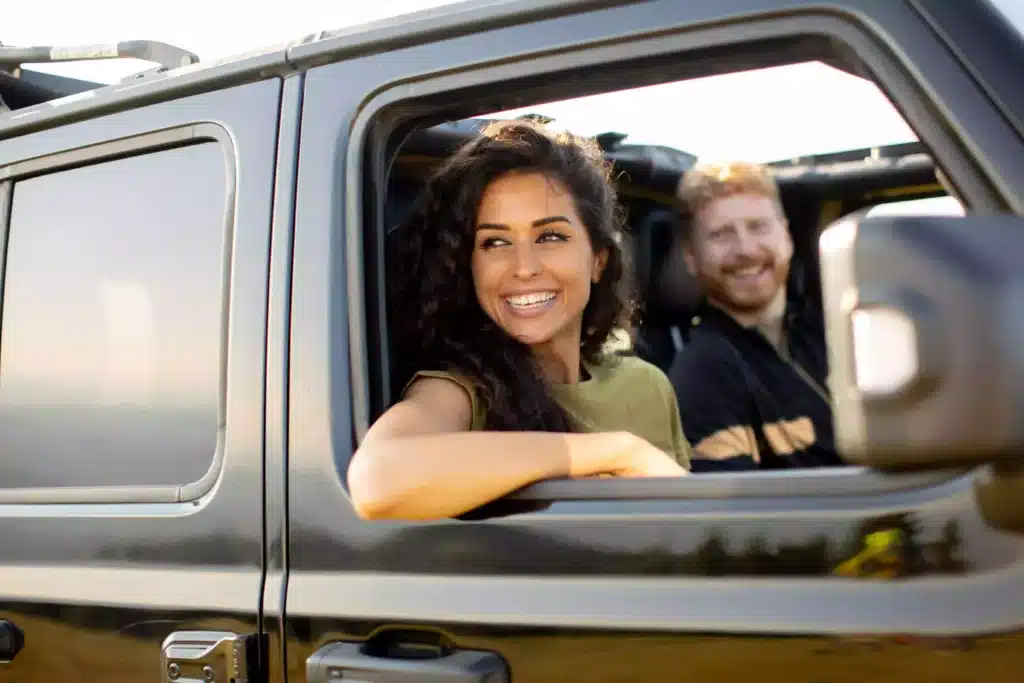 Close up of couple driving in vehicle