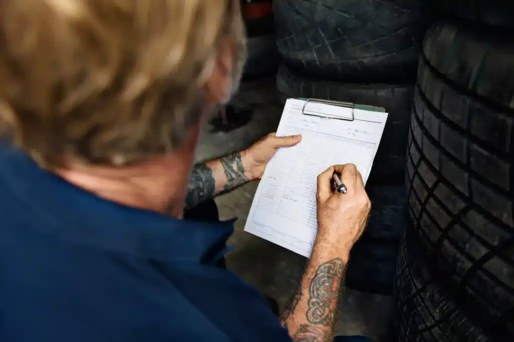 Mechanic filling out paperwork